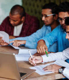 Group of four south asian men's posed at business meeting in caf